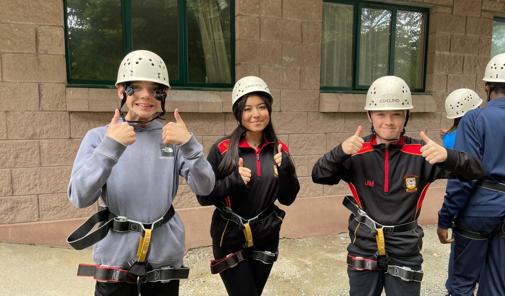 Year 10 students with their thumbs up in outdoor activity gear